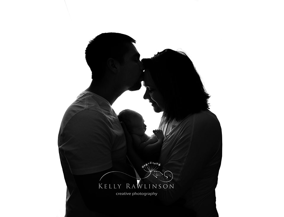 Bradford baby photographer, Kelly Rawlinson.  Black and white silhouette of new baby with parents.