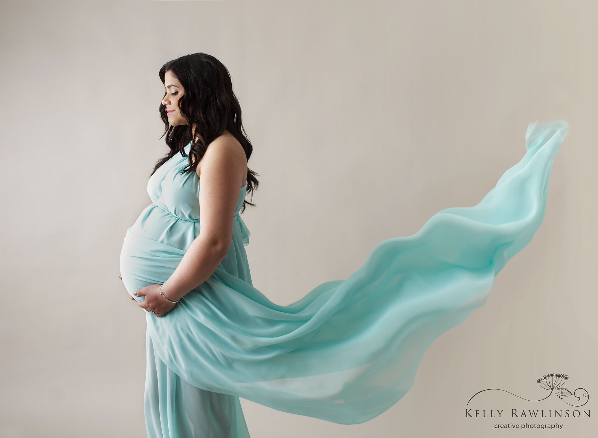 fabric dress blowing behind pregnant woman, professional photography in newmarket, keswick, sutton