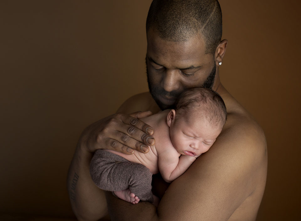 Professional photo of baby in dads arms