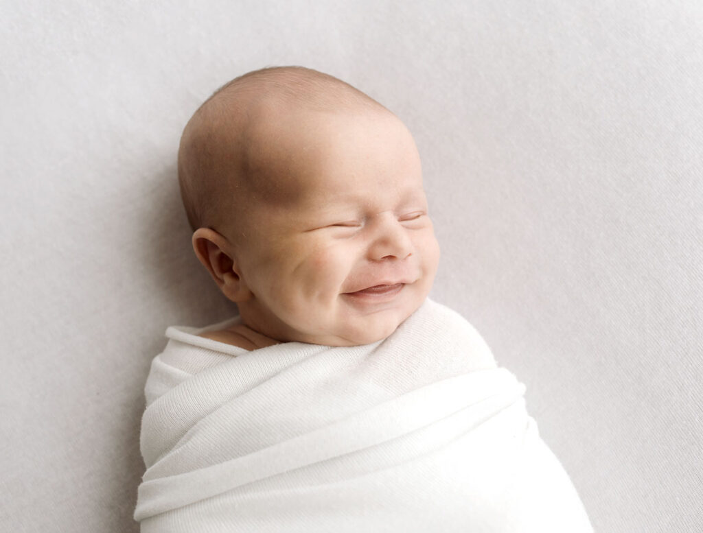 Newborn smiling baby