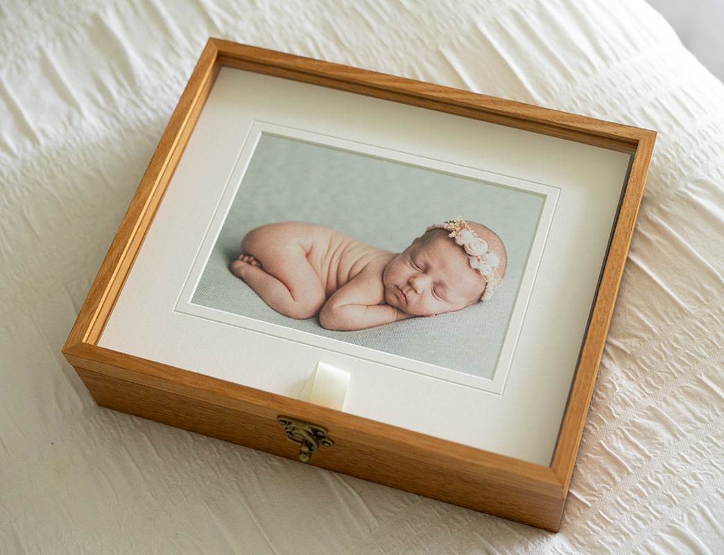Professional newborn photo products: pictured is a portrait box containing matted prints. Available from Newborn Photographer Kelly Rawlinson