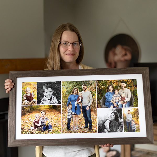 Family Photographer Kelly Rawlinson holds framed collage from family session