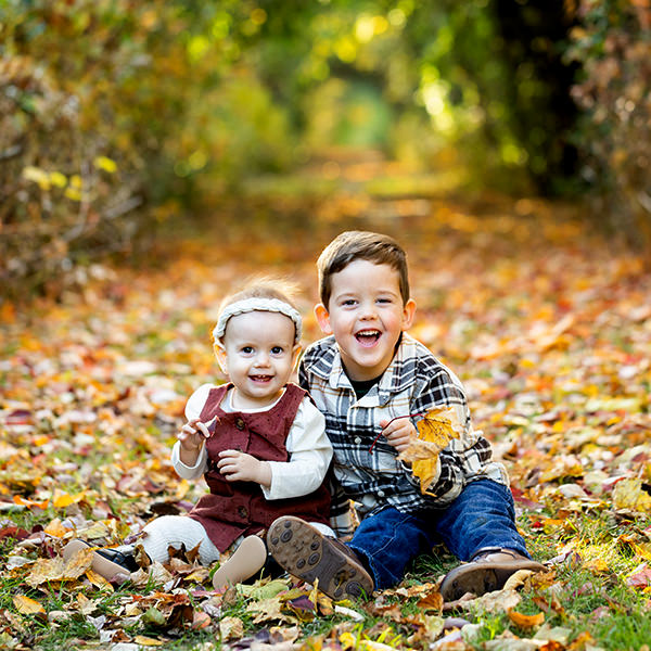 two children smiling at fall family photo session, newmarket
