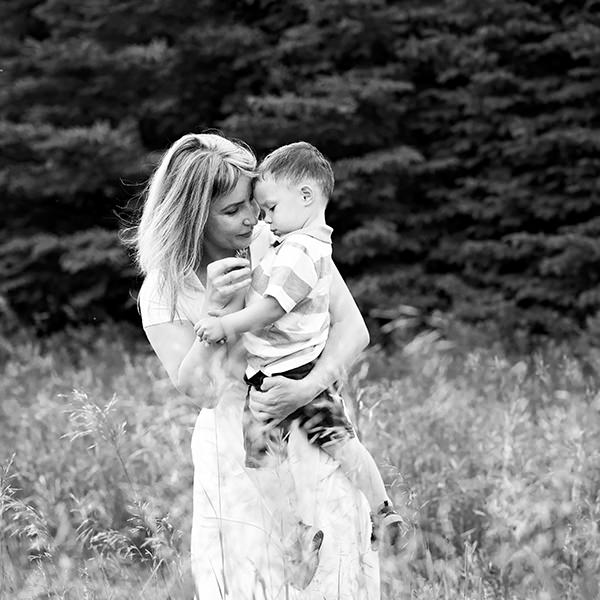 black and white family photo, mom holding young son