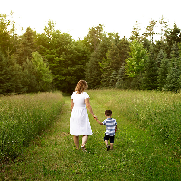 Mom and son walk in field, family photoshoot Durham region