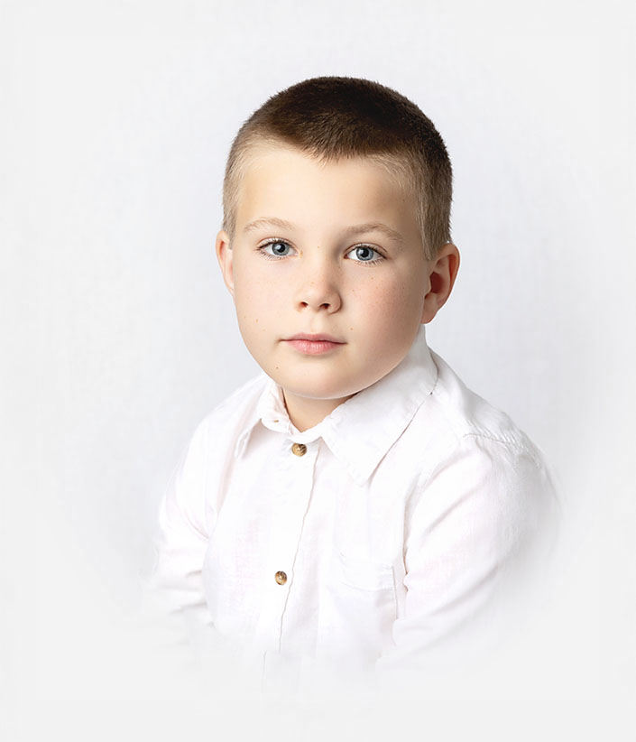 Timeless ortrait of boy with serious look, Heirloom style traditional portrait