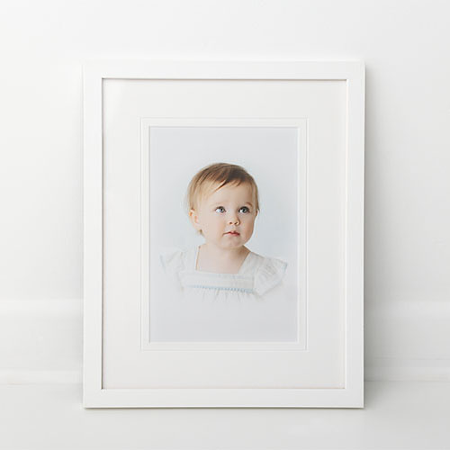 Compliment your home with simple white framed portrait of child