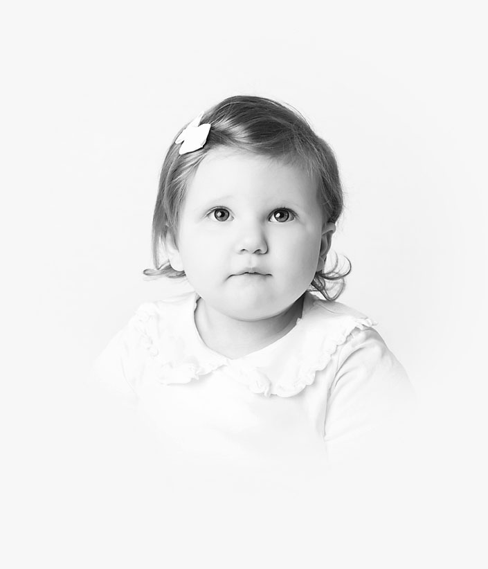 Black and white portrait of a toddler girl, worthy of being displayed in the home