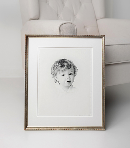 Framed portrait of young child with simple white backdrop