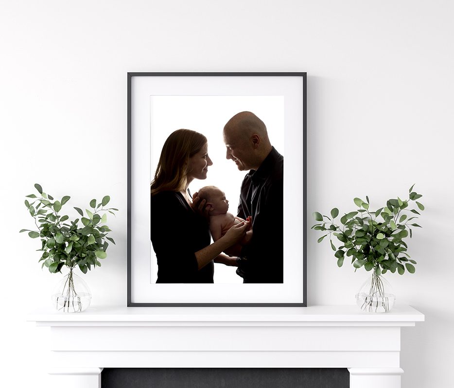 Frame mockup with plants standing on fireplace, white living roo